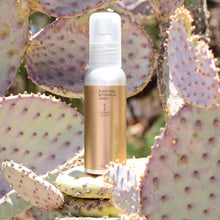 Load image into Gallery viewer, Purifying Botanical Wash 60ml photographed on a Prickly Pear Cactus. Product is by Mikel Kristi Skincare, based in the Arizona desert. This product is Step 1: Cleanse, and comes in a 60ml aluminum pump bottle with metallic gold colored label.
